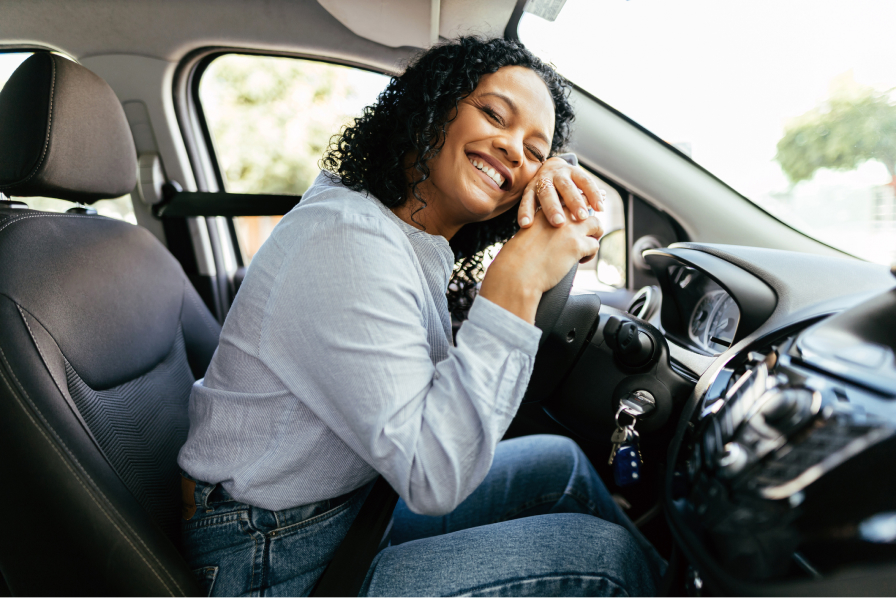 Lady leaning on vehicle steering wheel